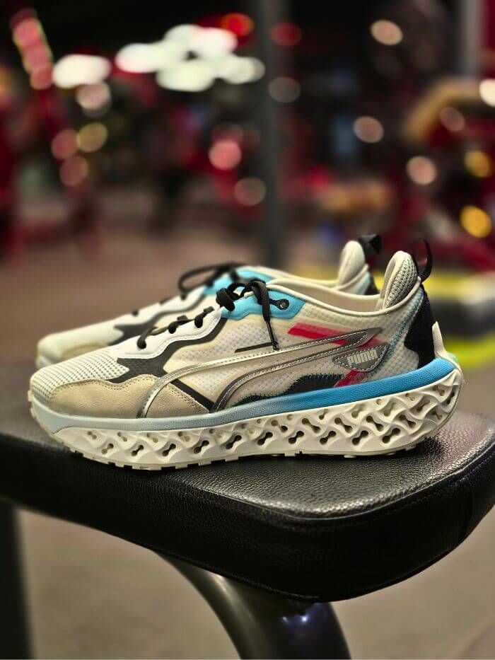 Close-up view of Puma training shoes placed on a gym bench